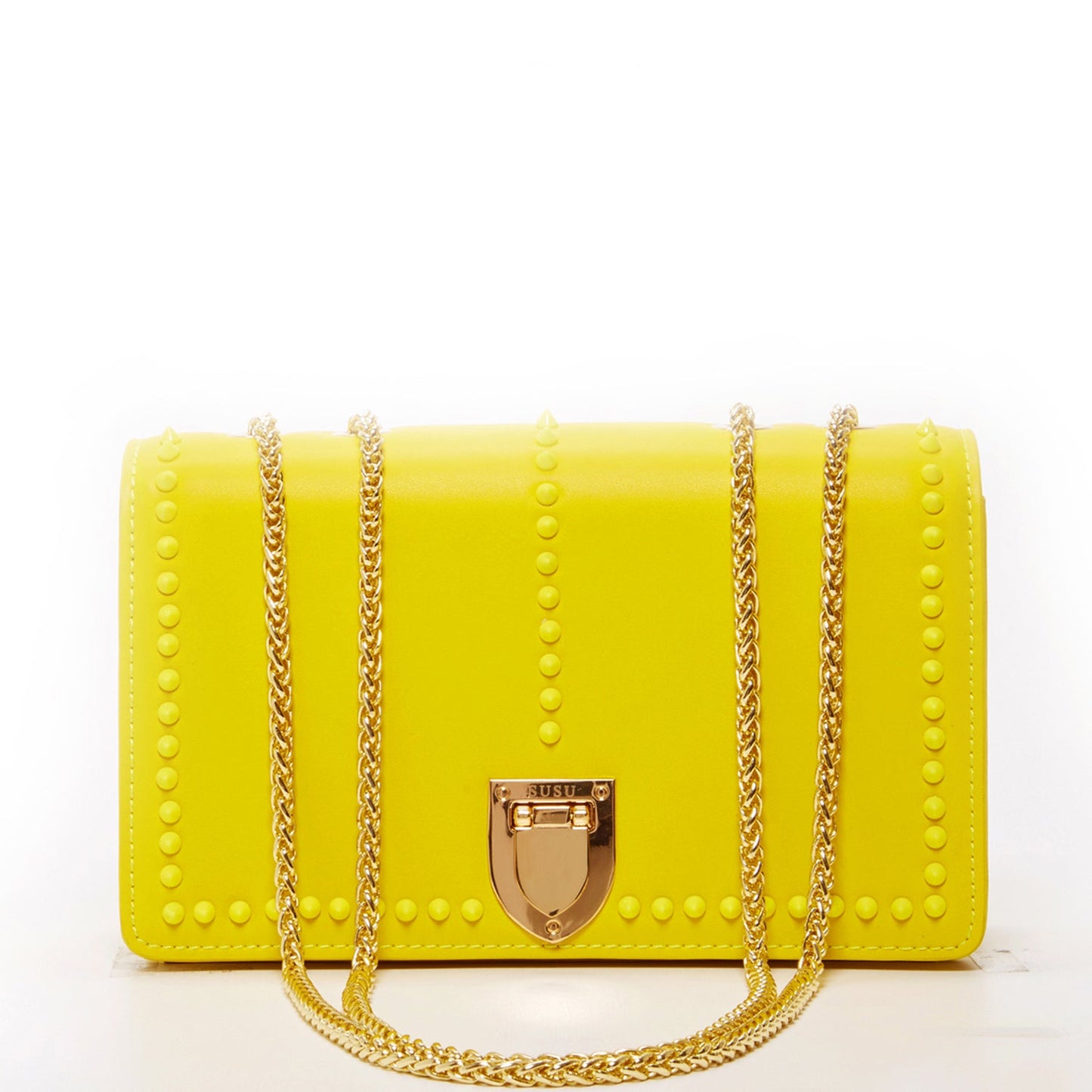 The SUSU Josie Mustard Yellow Leather Purse features gold chain straps, a clasp, and a front row of small studs.