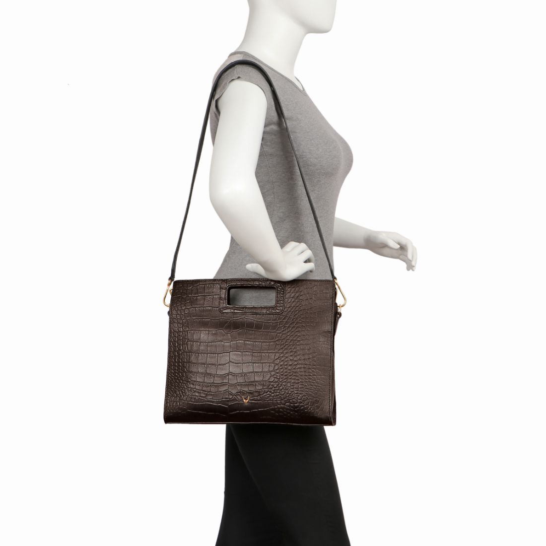 A Hidesign leather handbag in black features a textured design, rectangular cutout handle, and detachable shoulder strap.