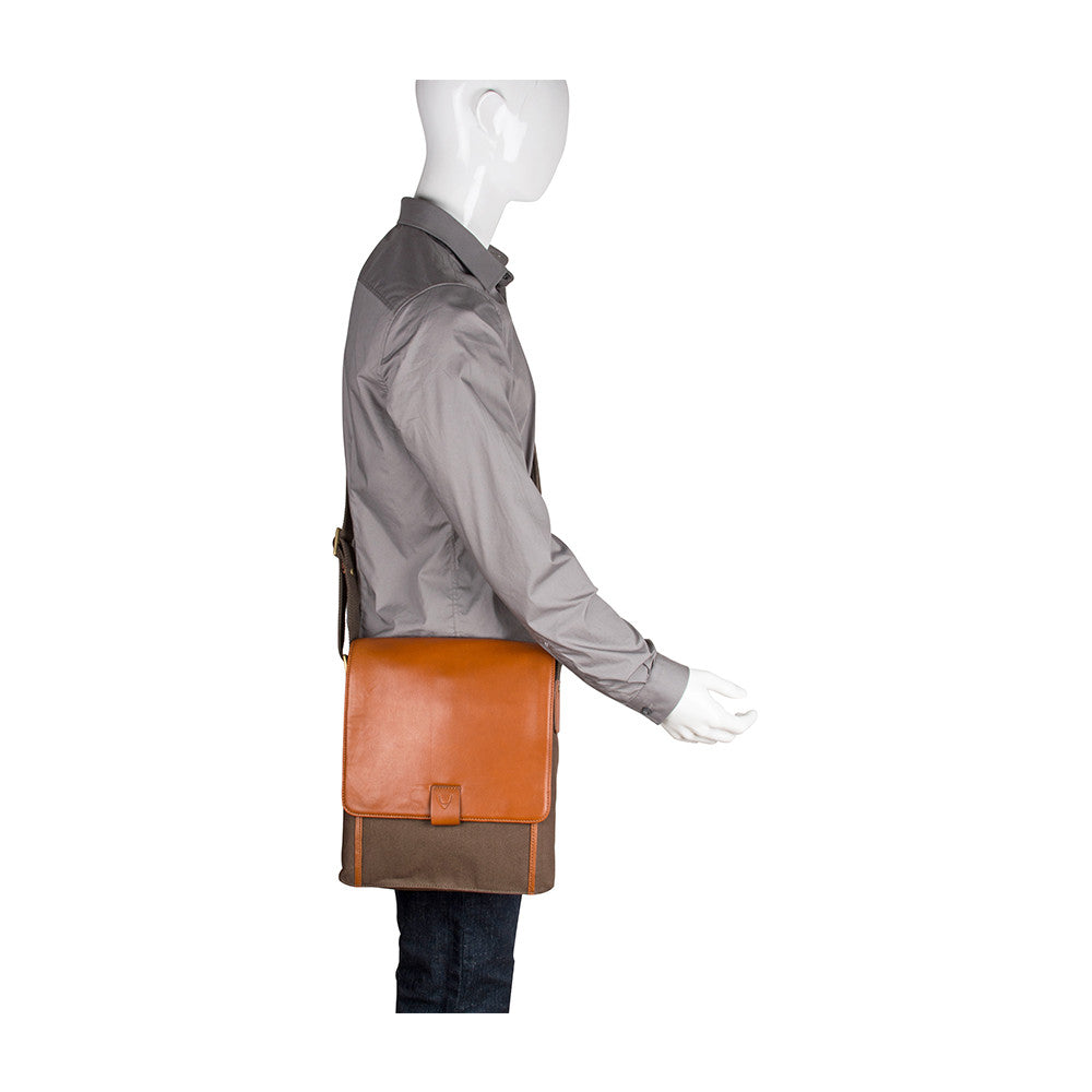 The Aiden Hidesign Blue Genuine Leather and Canvas Crossbody Bag features an adjustable strap and buckle, perfect for men or women as a shoulder, messenger, or travel bag that fits a 10.5 iPad.