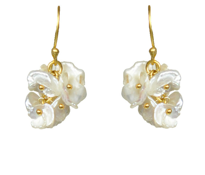 Gena Myints Short Keshi Pearl Cluster Earrings feature gold-hook dangling earrings adorned with clusters of petal-like motifs and gold bead accents.