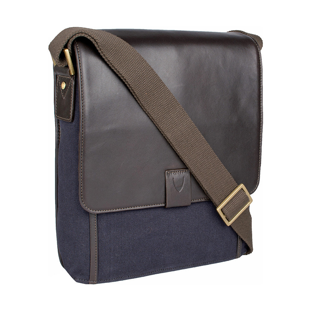 The Aiden Hidesign Blue Genuine Leather and Canvas Crossbody Bag features an adjustable strap and buckle, perfect for men or women as a shoulder, messenger, or travel bag that fits a 10.5 iPad.