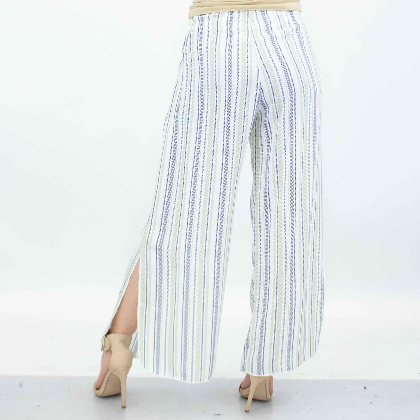 A person wearing Stylespects Side Slit Wide Leg Pants in green and beige high heels stands against a plain background.