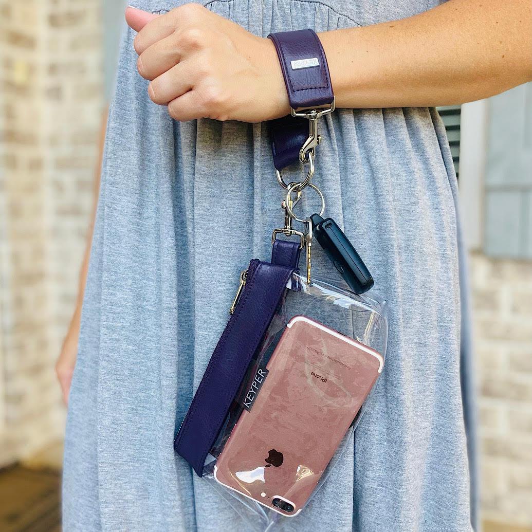 A Pretty Purple Vegan Leather Bag by KEYPER features a gold zipper and strap, showcased on a white background.