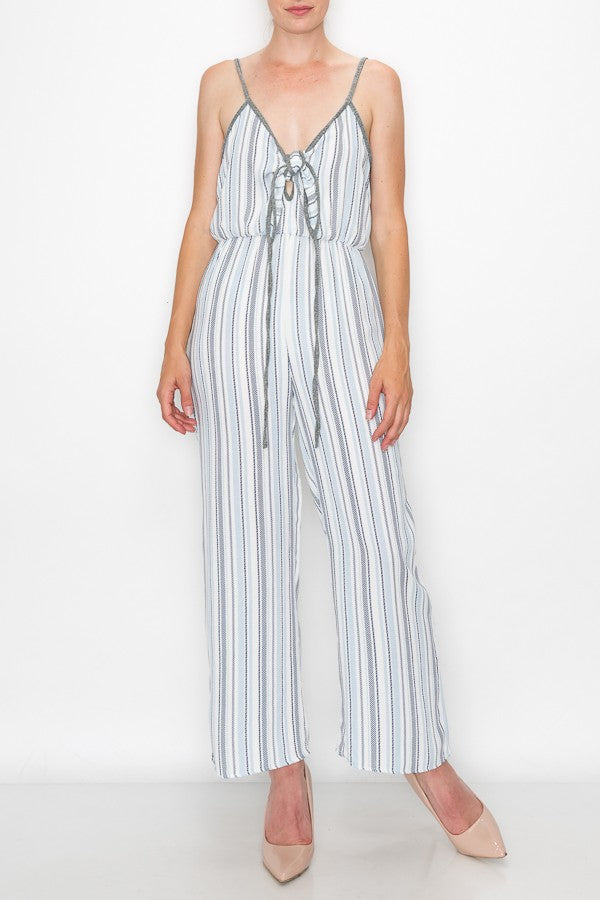 Someone is wearing the Stylespect Front Tie Cropped Jumpsuit in blue with stripes and wide legs, paired with beige pointed heels.