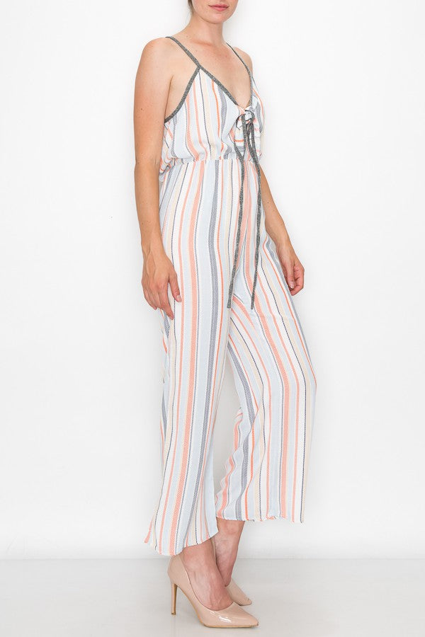 A person wearing the Stylespect Front Tie Cropped Jumpsuit in orange and beige heels stands against a plain white background.