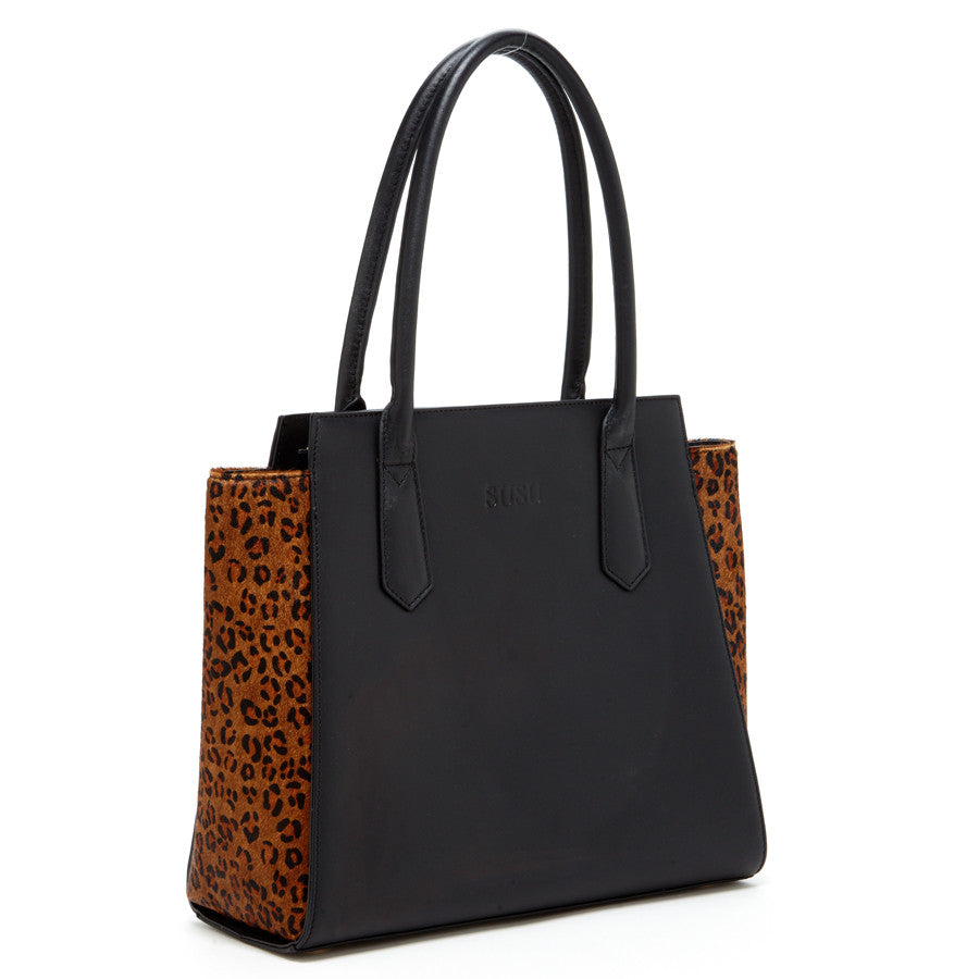 The SUSU Jody Black Leather Tote Bag features a stylish leopard print design and two handles.