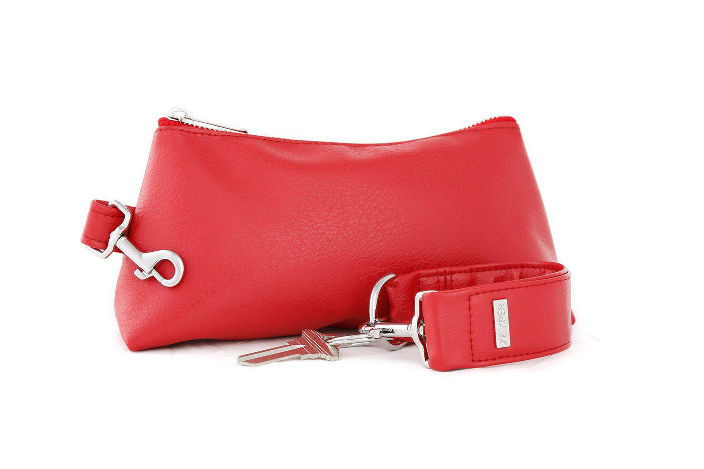 A red vegan leather wristlet set from KEYPER, featuring a gold zipper and detachable strap with gold hardware.