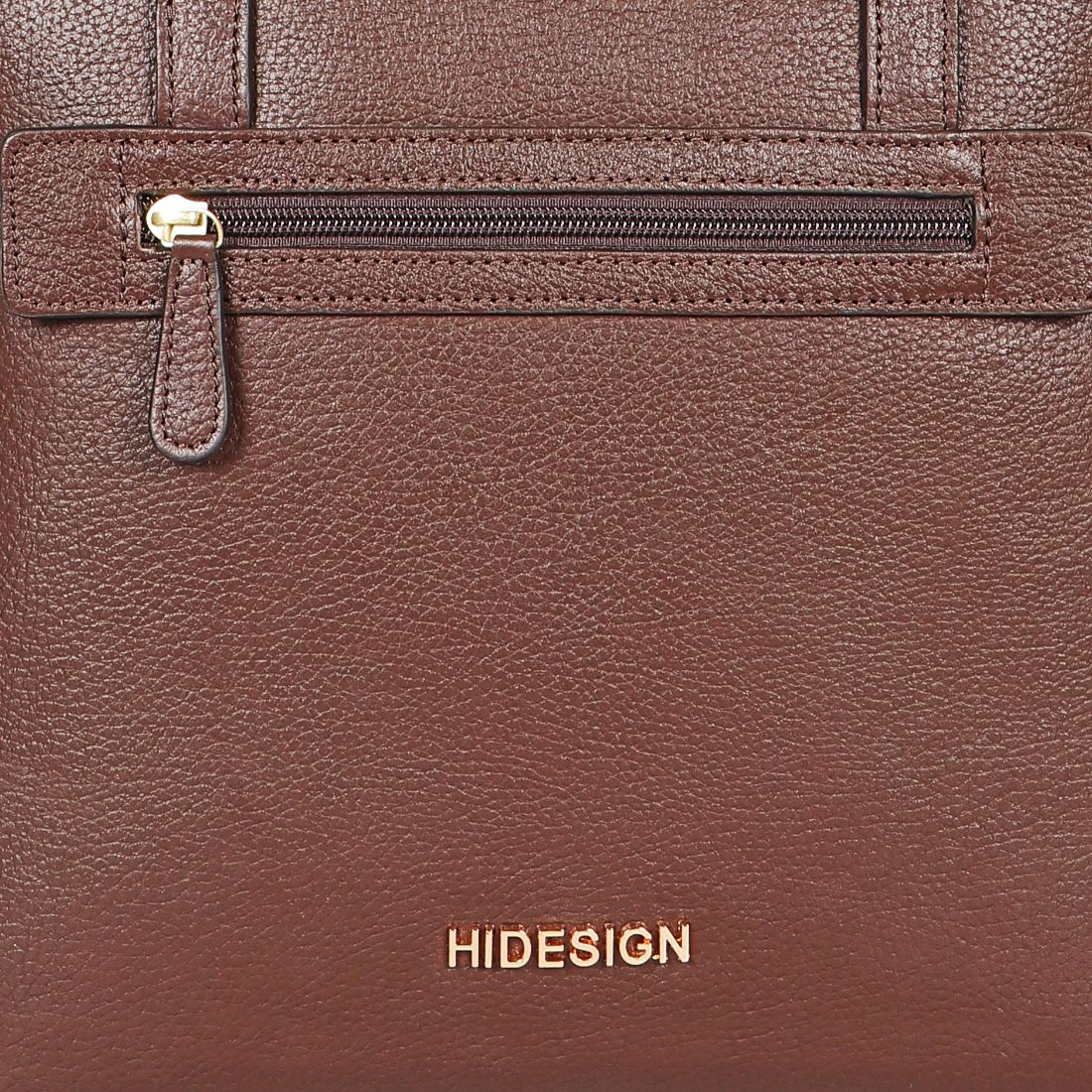 A black Hidesign Clarida Womens Classic Leather Handbag with two shoulder straps, a zippered front pocket, and HIDESIGN embossed in gold at the bottom.