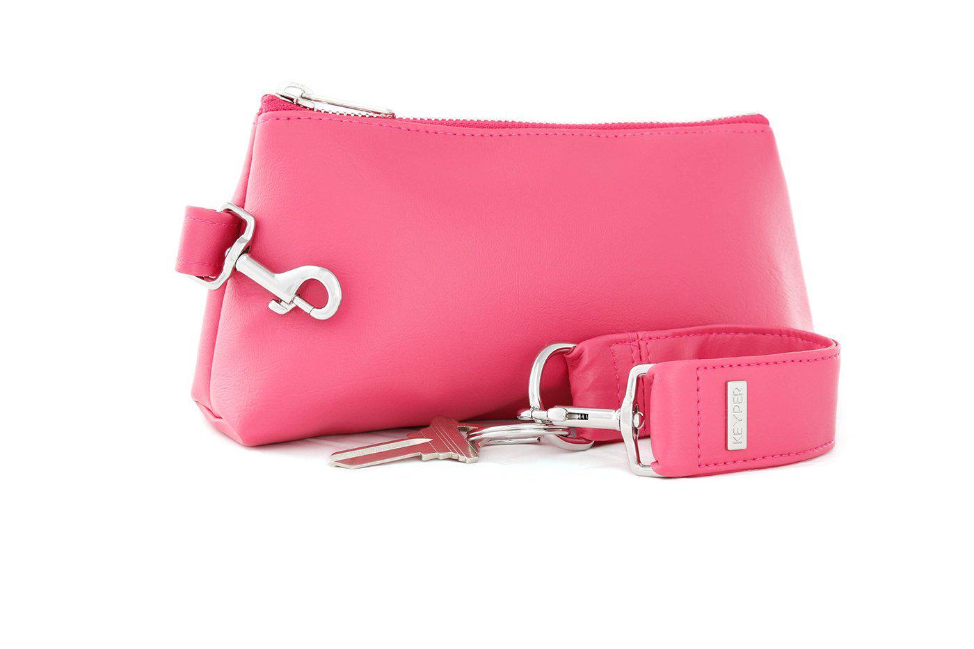 The KEYPER Bright Pink Vegan Leather 2-Piece WRISTLET SET includes a small pink pouch with a zipper, gold clasp, an attached pink strap, and a set of keys.