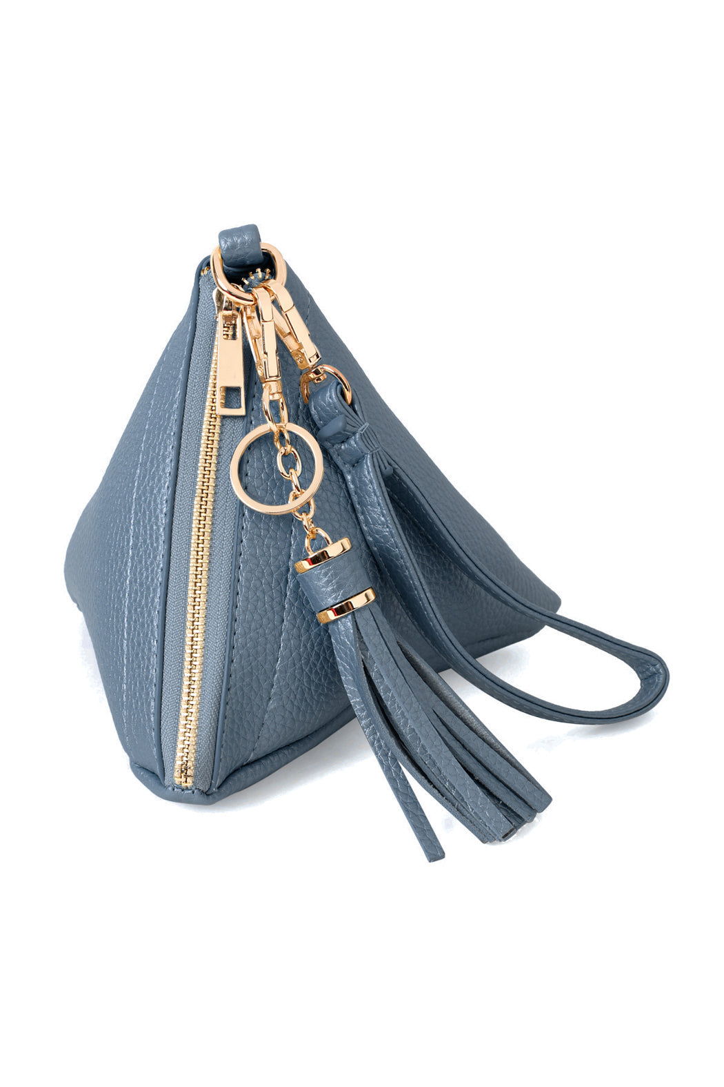 A person in a white shirt and jeans is holding the Riah Fashion Pyramid Shape Tassel Wristlet Leather Bag in orange.