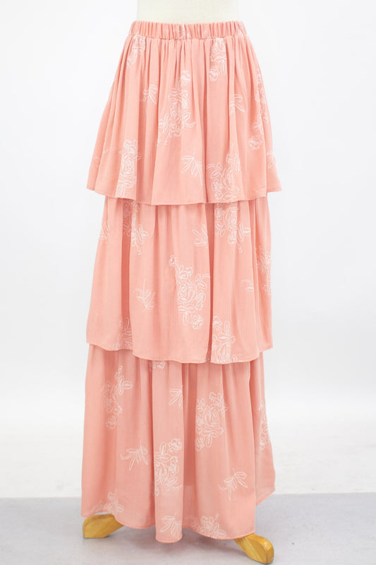 A Stylespect Layered Ruffle Maxi Skirt in blush is shown on a mannequin against a plain backdrop.