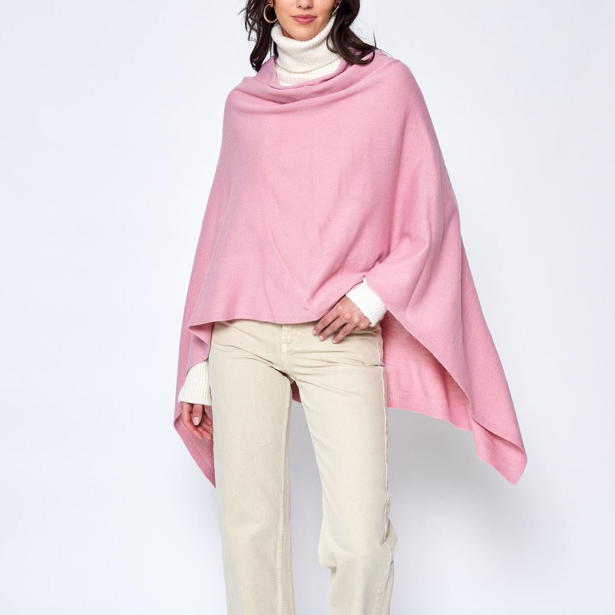 Someone wearing the Take With Me Travel Poncho by Ellison + Young with plaid pants against a plain white background.