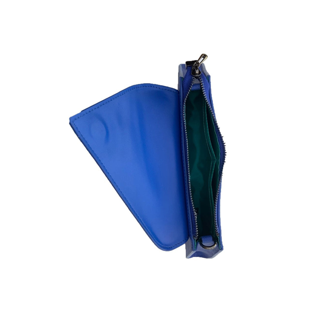 A SUSU Angelica Cobalt Blue Leather Clutch Bag featuring a triangular flap design and a silver chain strap.