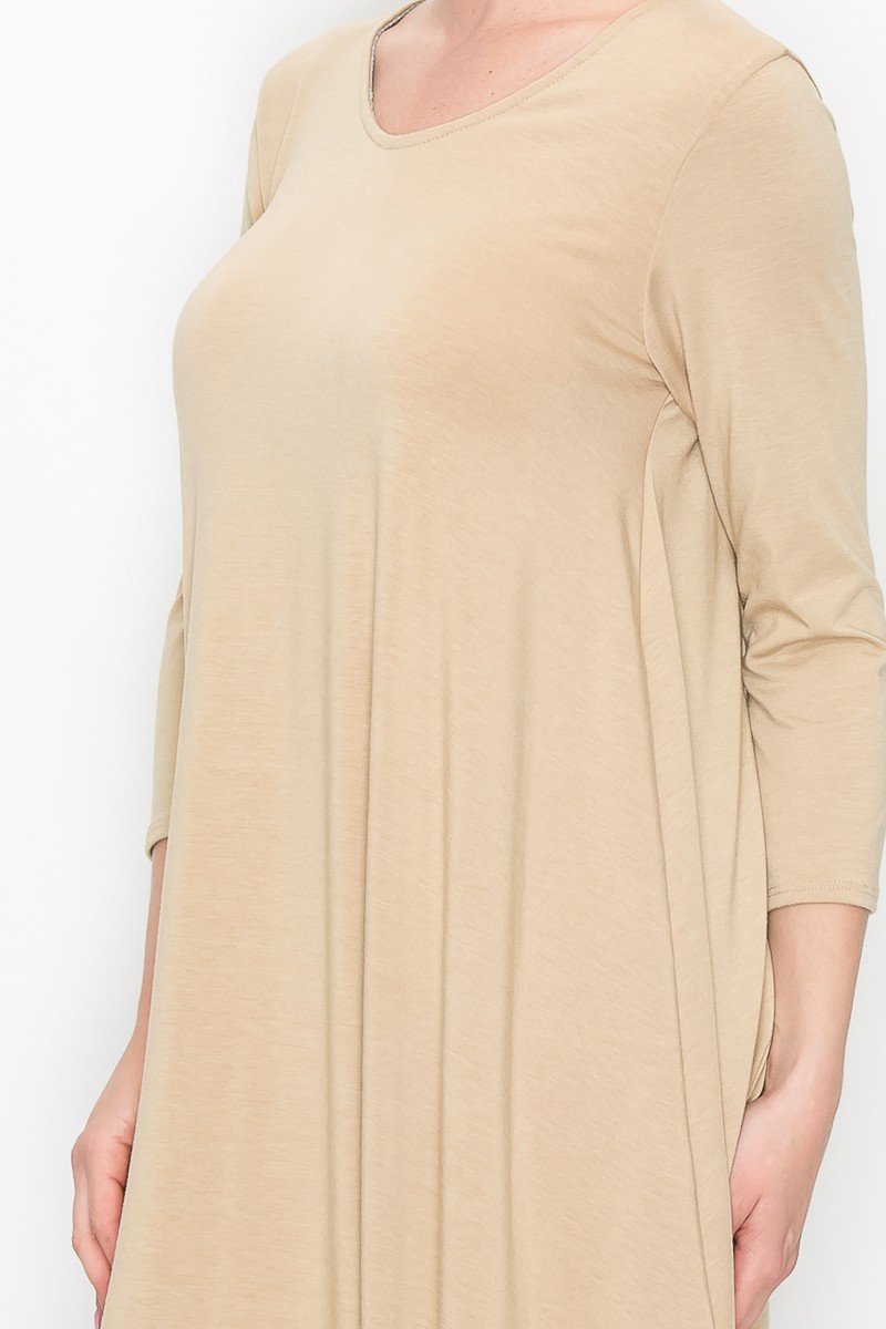 A person poses against a white background wearing the Stylespect Solid Balloon Dress in beige, featuring long sleeves and paired with beige heels, with one hand on their hip.