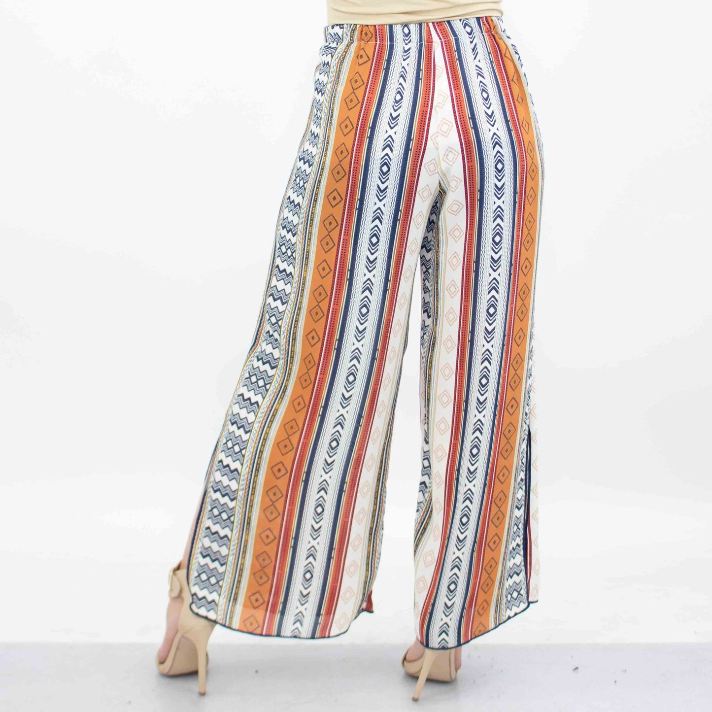 A person dressed in Stylespects Side Slit Wide Leg Cropped Pants and beige heels stands against a white background.