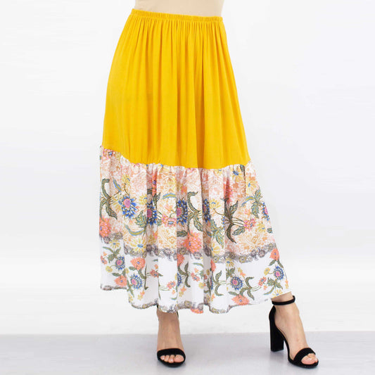 A person wearing a Stylespect Floral Color Block Skirt - Yellow paired with black high heels.