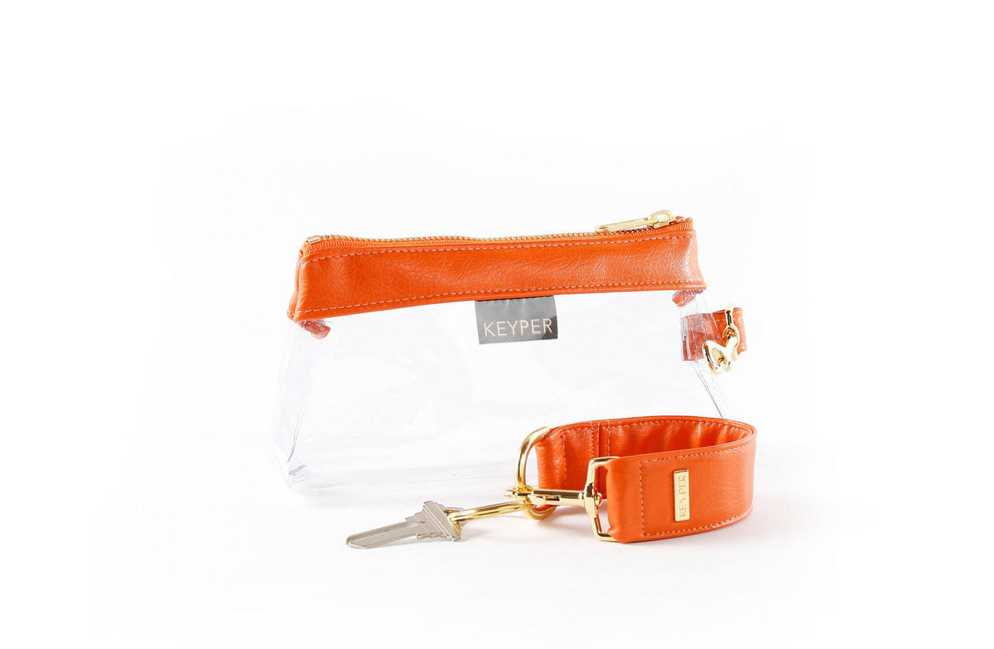The KEYPER Persimmon Vegan Leather 2-Piece Wristlet Set features a clutch bag with a gold zipper, detachable strap, and small gold keychain.