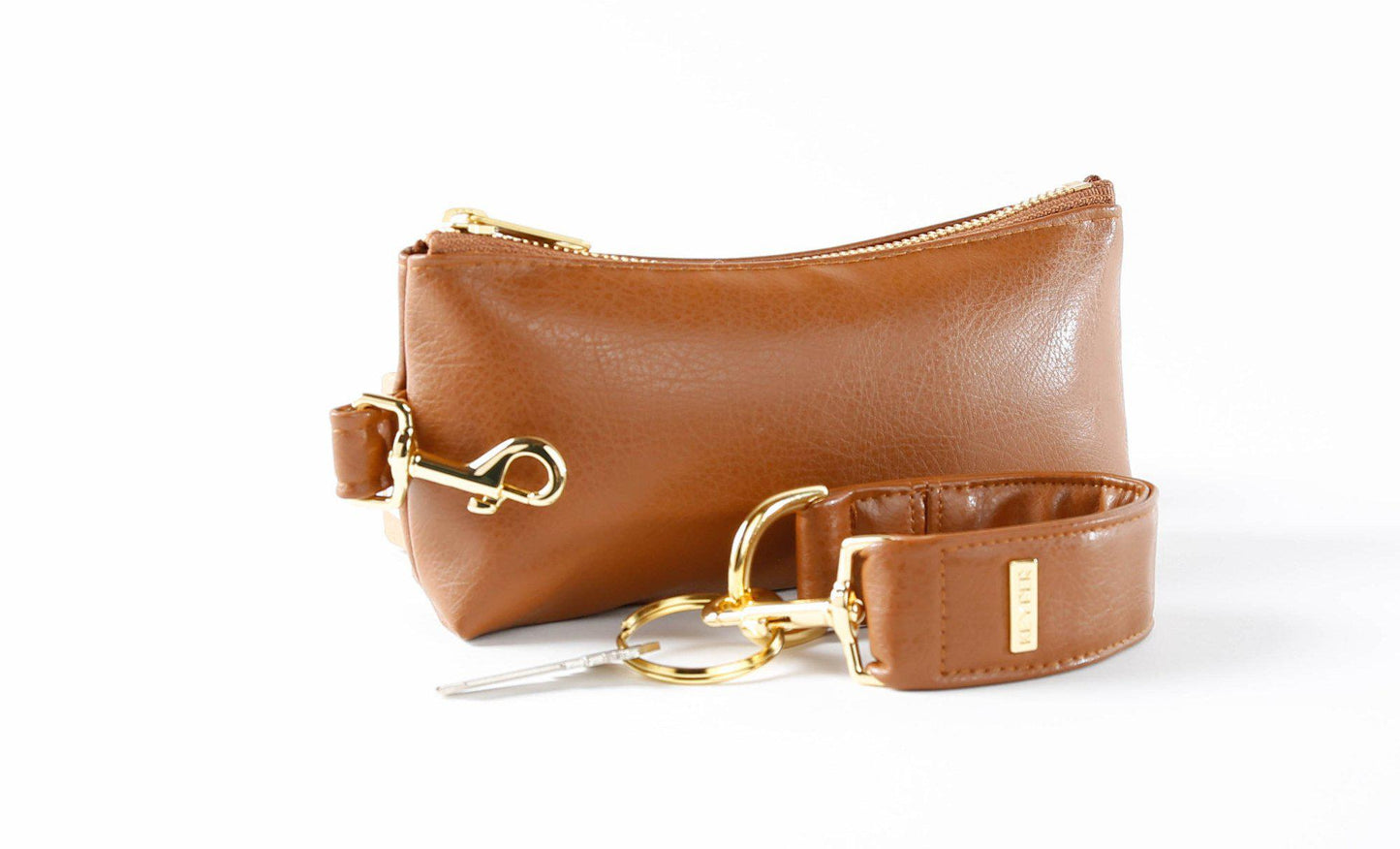 Saddle Brown Vegan Leather 2-Piece Wristlet Set by KEYPER, featuring a detachable matching strap and gold hardware, set against a white background.