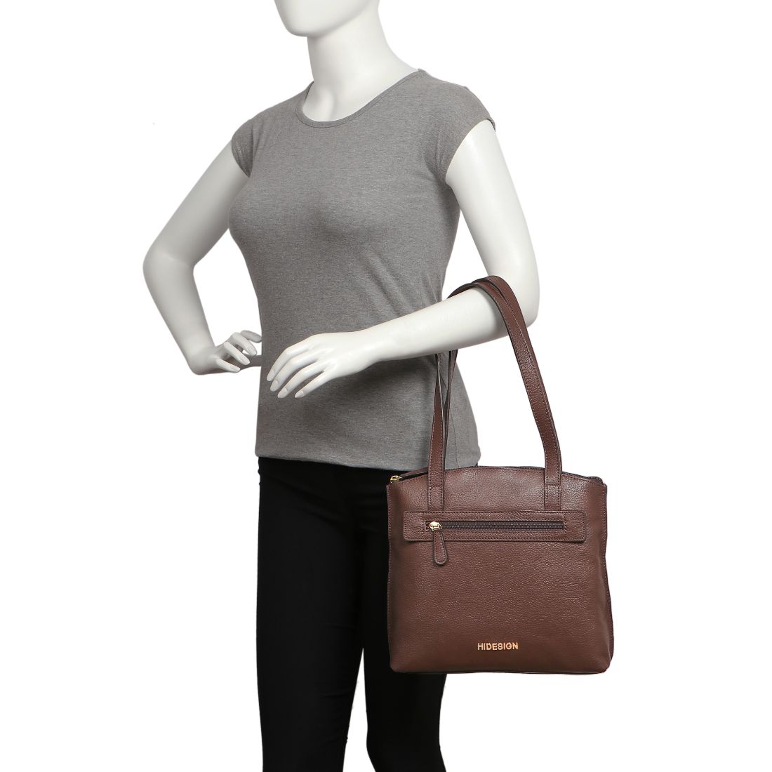 A black Hidesign Clarida Womens Classic Leather Handbag with two shoulder straps, a zippered front pocket, and HIDESIGN embossed in gold at the bottom.
