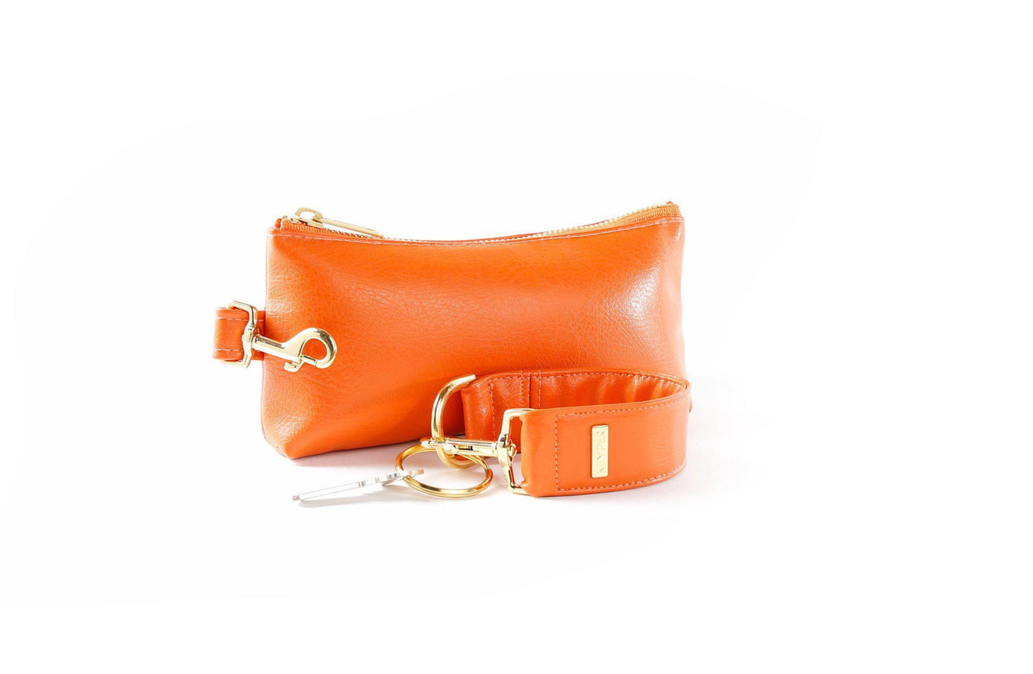 The KEYPER Persimmon Vegan Leather 2-Piece Wristlet Set features a clutch bag with a gold zipper, detachable strap, and small gold keychain.