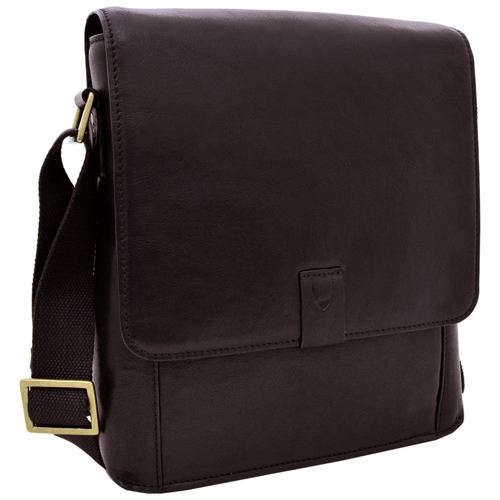 Hidesigns Aiden Genuine Leather Medium Crossbody is a dark brown shoulder bag featuring a wide strap and rectangular brass buckle.