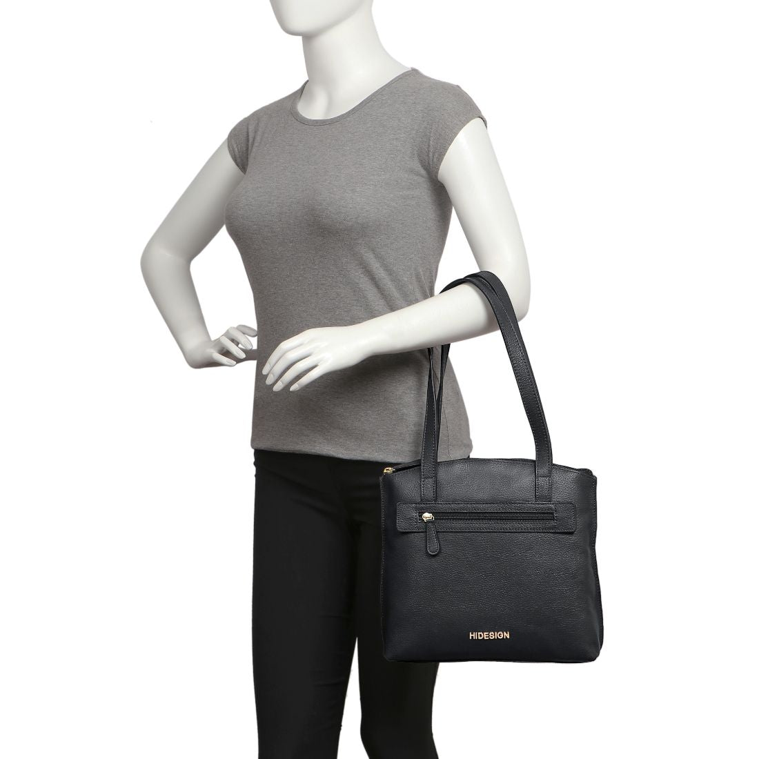A black Hidesign Clarida Womens Classic Leather Handbag with two shoulder straps, a zippered front pocket, and HIDESIGN embossed in gold at the bottom.