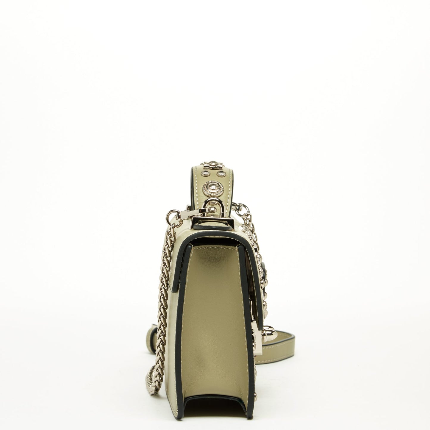 The Hollywood Leather Crossbody Bag by SUSU in sage green features metallic studs and chain straps, elegantly displayed against a plain background.