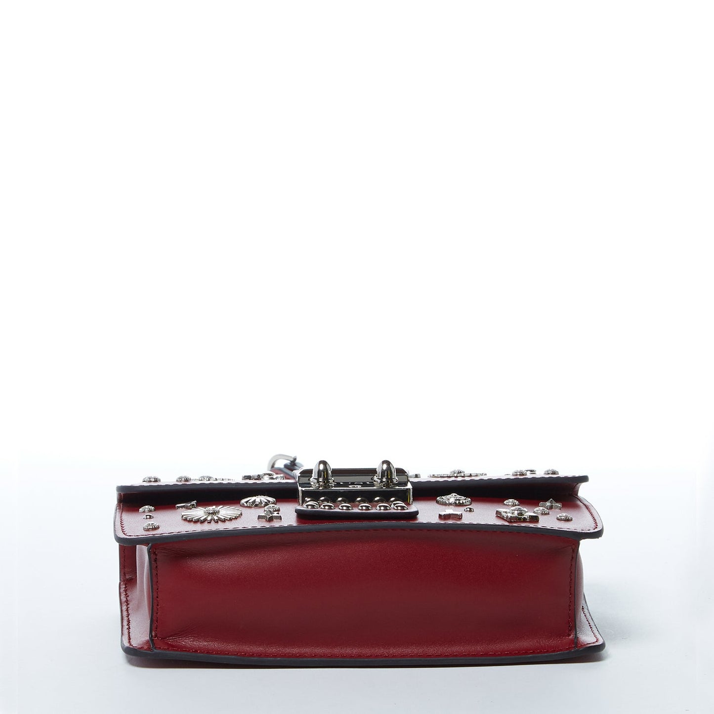 Burgundy leather handbag with silver studs, a short handle, and chain shoulder strap, featuring a SUSU engraved metal clasp.