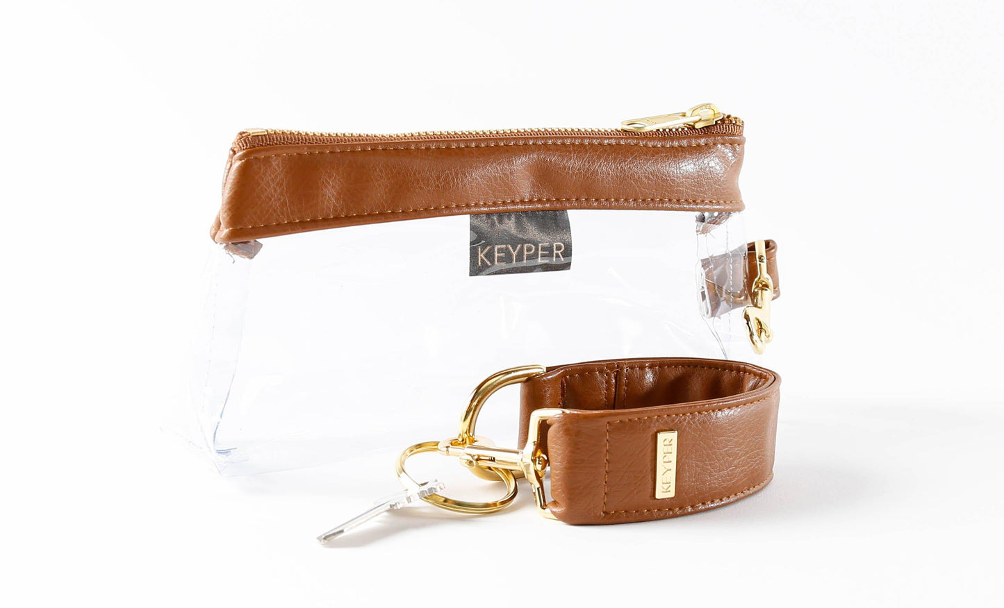 Saddle Brown Vegan Leather 2-Piece Wristlet Set by KEYPER, featuring a detachable matching strap and gold hardware, set against a white background.