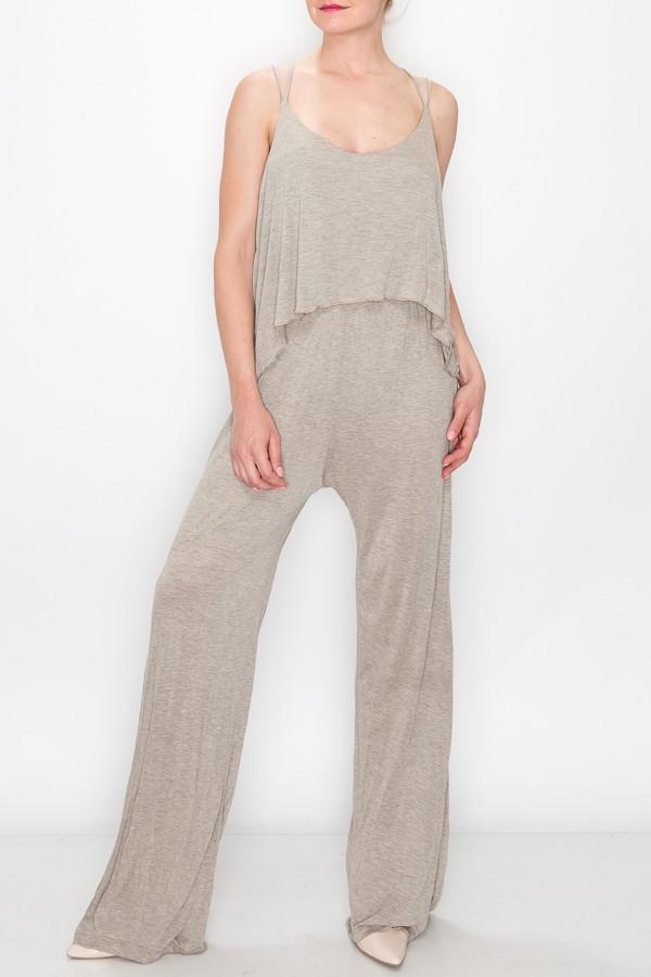 A person models the Stylespect Layered Jumpsuit in khaki, featuring a light gray, sleeveless, loose-fitting design, against a plain white backdrop.