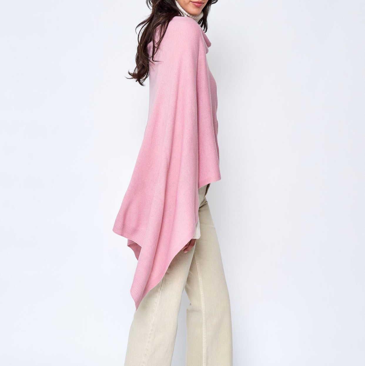 Someone wearing the Take With Me Travel Poncho by Ellison + Young with plaid pants against a plain white background.