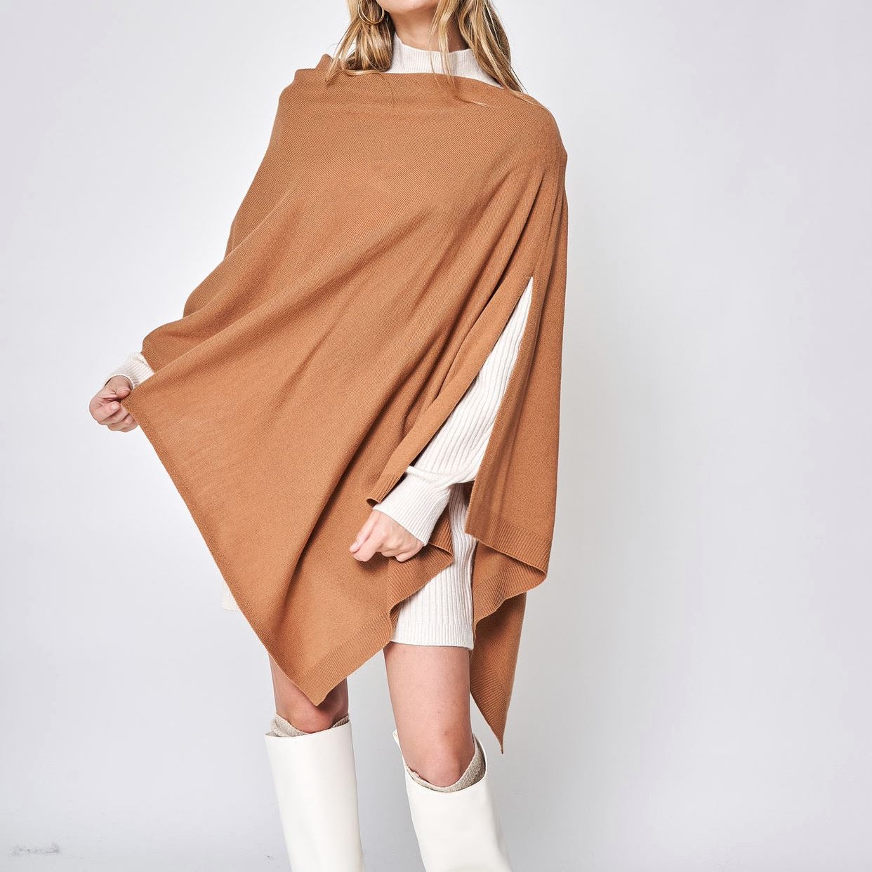 Someone wearing the Take With Me Travel Poncho by Ellison + Young with plaid pants against a plain white background.