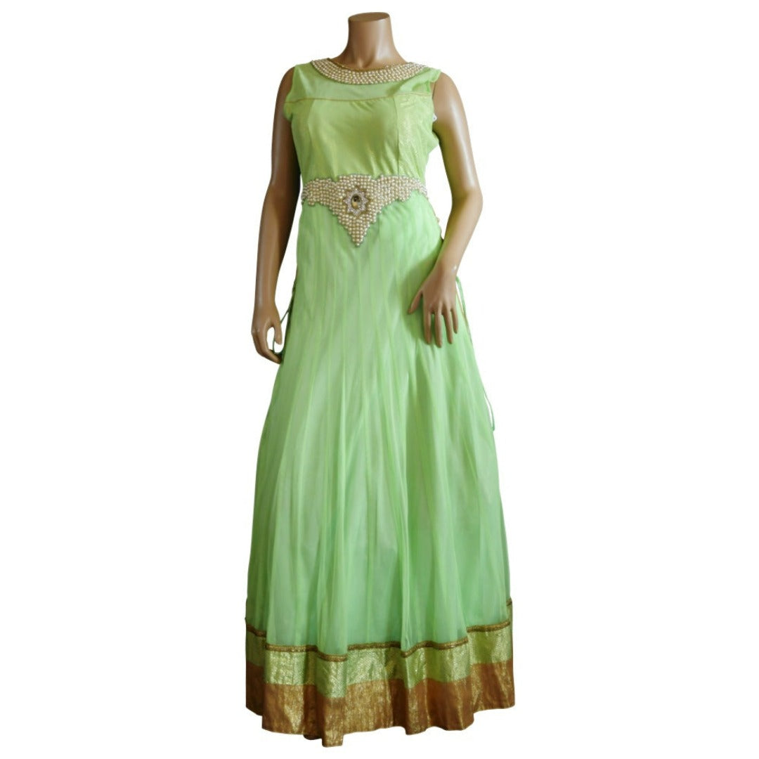 A mannequin displays a Chiros Light Green Embroidered Floor Length Gown, featuring a sleeveless design with gold trim and beaded embellishments on the neckline and waist.