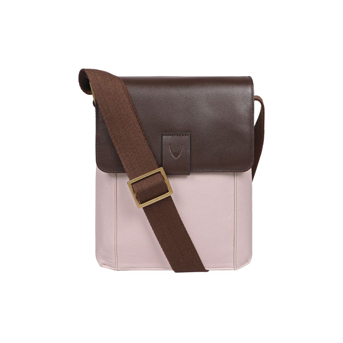 The Aiden Genuine Leather Mini Crossbody by Hidesign is a brown leather shoulder bag featuring a flap cover and an adjustable fabric strap with a brass buckle.