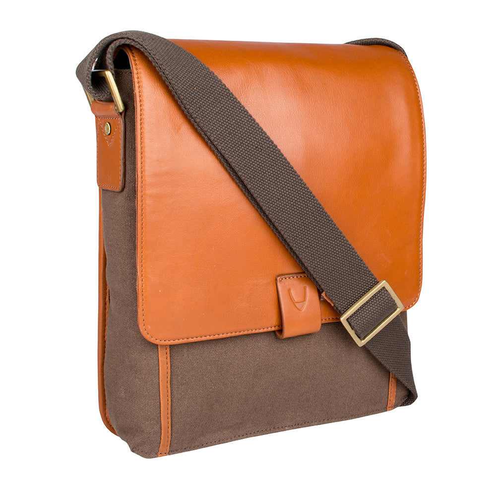 The Aiden Hidesign Blue Genuine Leather and Canvas Crossbody Bag features an adjustable strap and buckle, perfect for men or women as a shoulder, messenger, or travel bag that fits a 10.5 iPad.