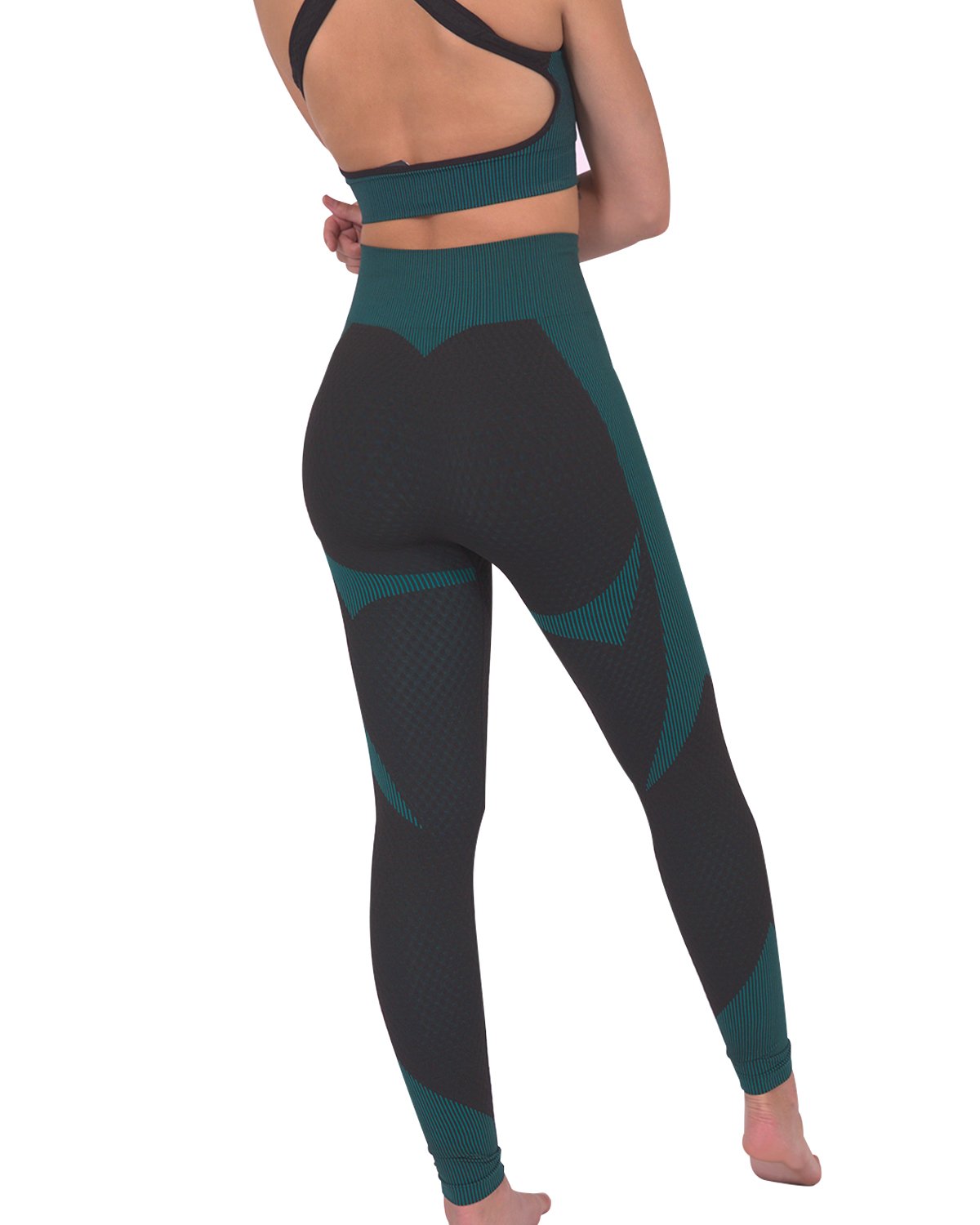 A person wearing Savoy Actives Trois Seamless Legging in Black with Teal Blue and black sneakers stands against a gray textured wall.