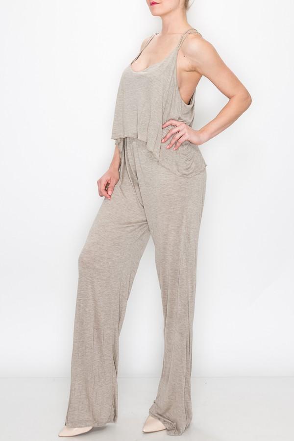 A person models the Stylespect Layered Jumpsuit in khaki, featuring a light gray, sleeveless, loose-fitting design, against a plain white backdrop.