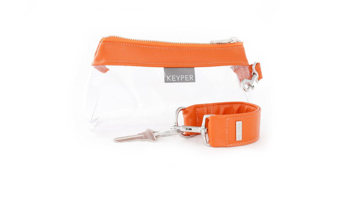 The KEYPER Persimmon Vegan Leather 2-Piece Wristlet Set features a clutch bag with a gold zipper, detachable strap, and small gold keychain.