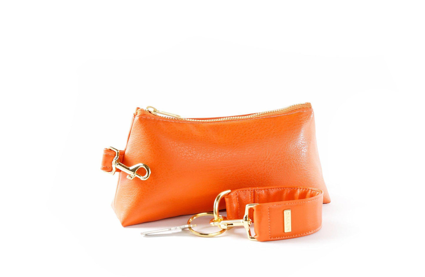 The KEYPER Persimmon Vegan Leather 2-Piece Wristlet Set features a clutch bag with a gold zipper, detachable strap, and small gold keychain.