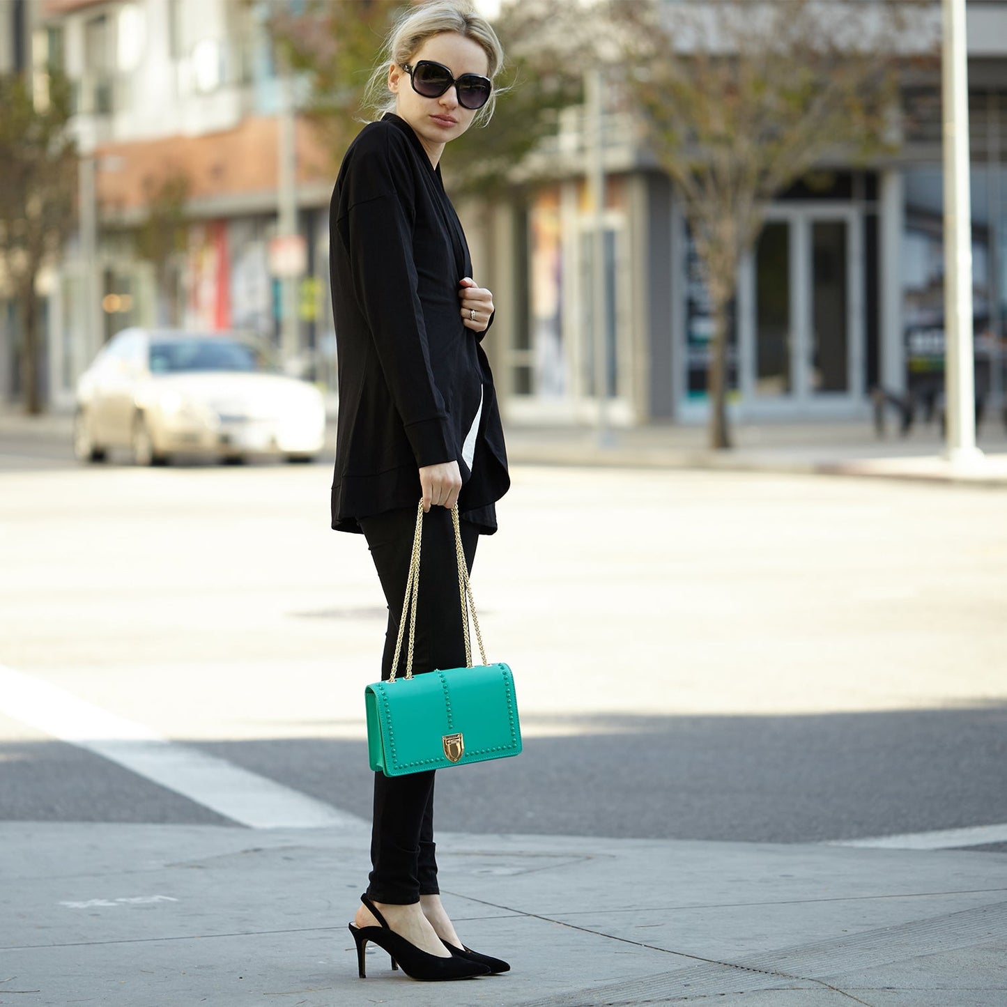 SUSU presents the Josie Green Leather Bag featuring a studded design and a gold chain strap.