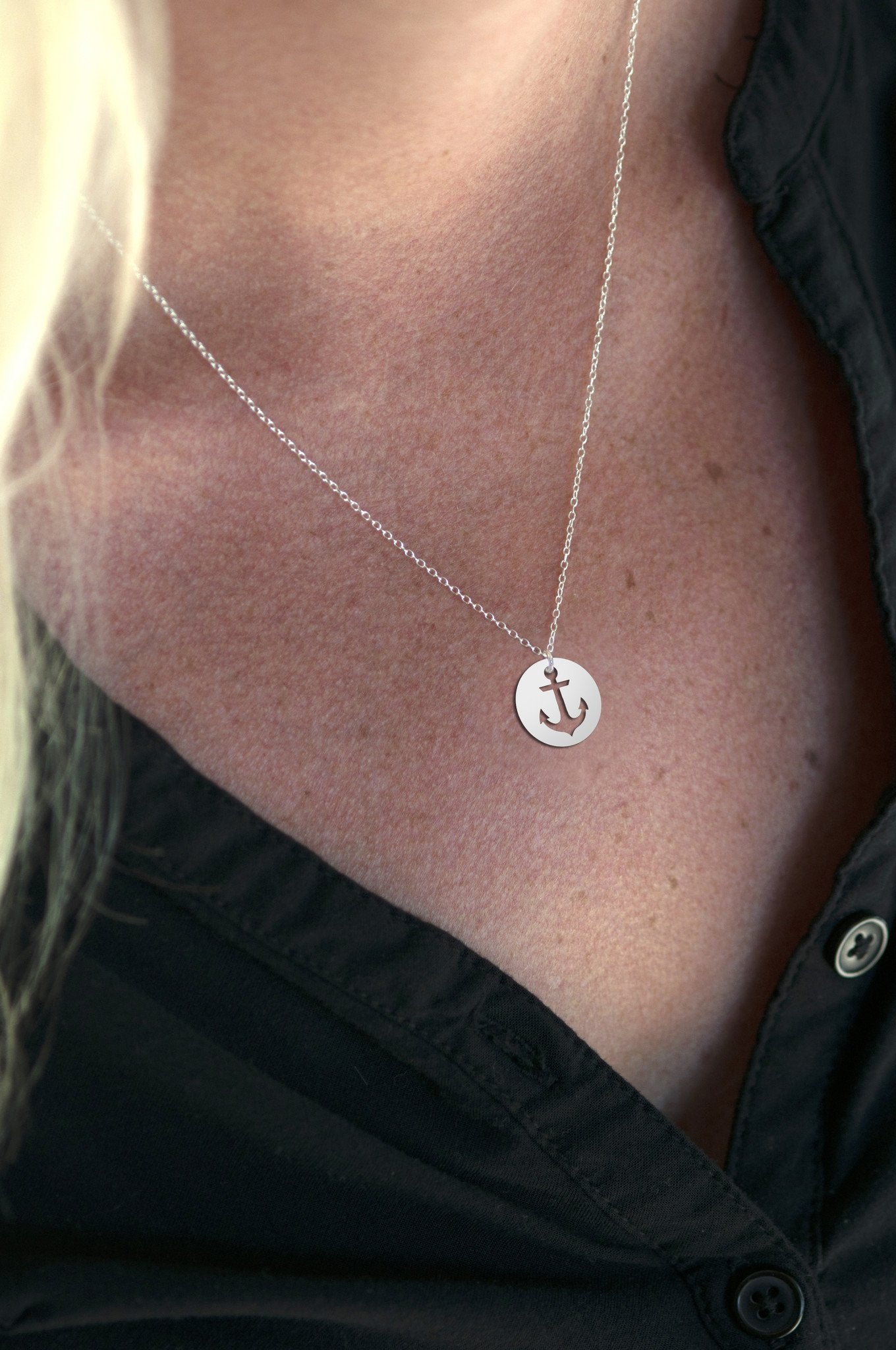 Sincerely Silvers Anchor Necklace is a sterling silver piece showcasing a circular pendant with a cut-out anchor design.