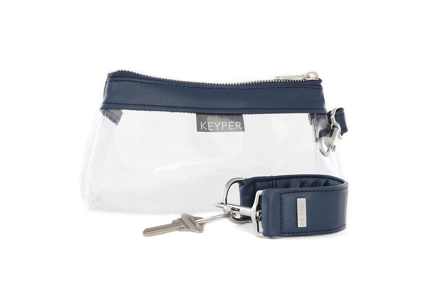 A compact True Navy vegan leather bag by KEYPER, with a gold zipper and clasp, comes with a detachable strap and includes a silver key attached to a key ring. Part of the 2-piece wristlet set.