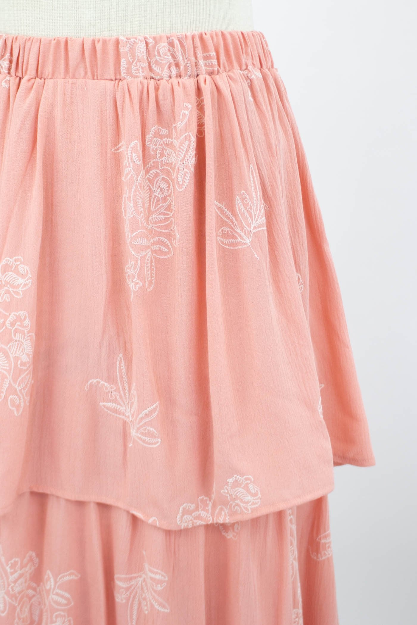A Stylespect Layered Ruffle Maxi Skirt in blush is shown on a mannequin against a plain backdrop.
