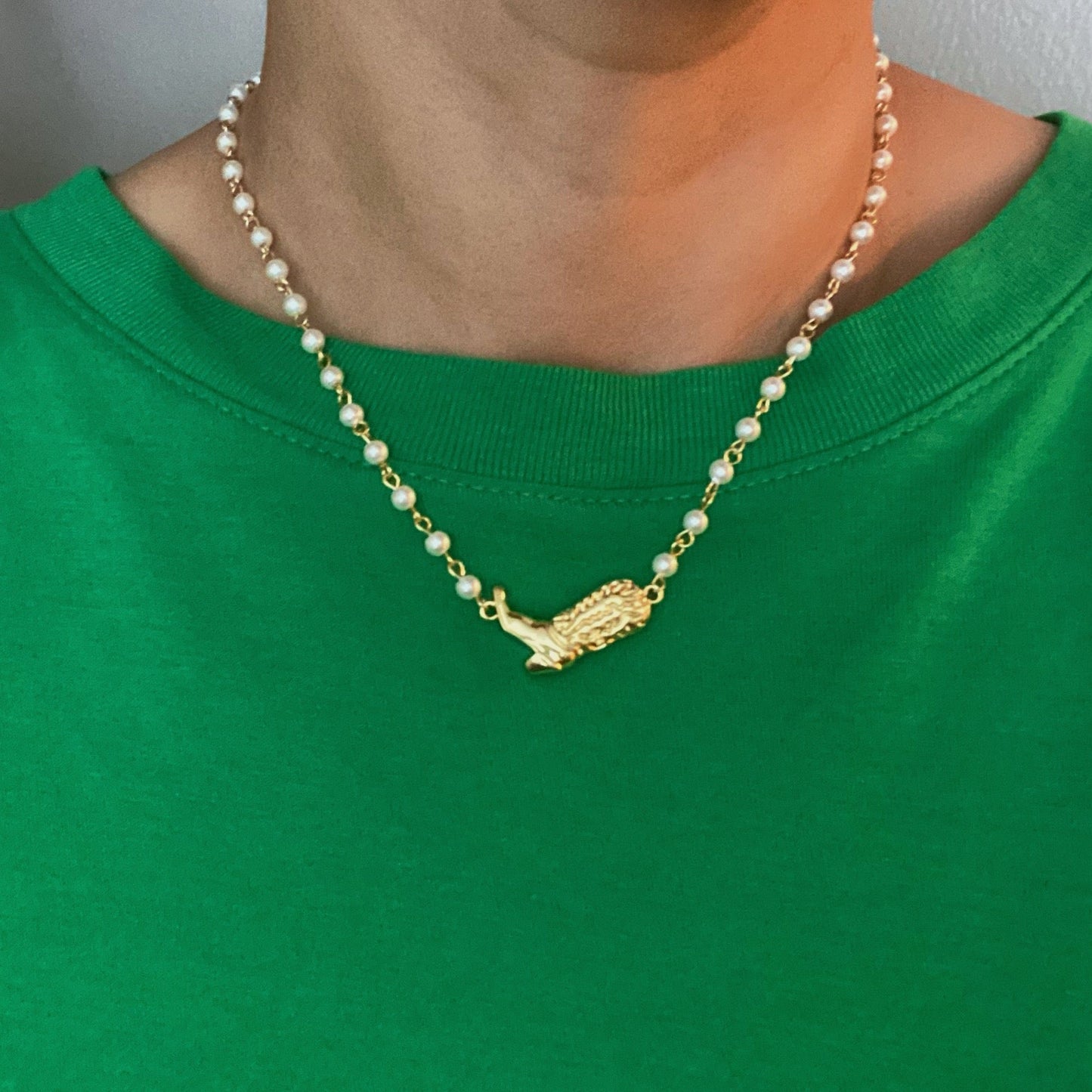 Ellison + Youngs Cowgirl Boot Pearl Chain Necklace is displayed on a marble surface.