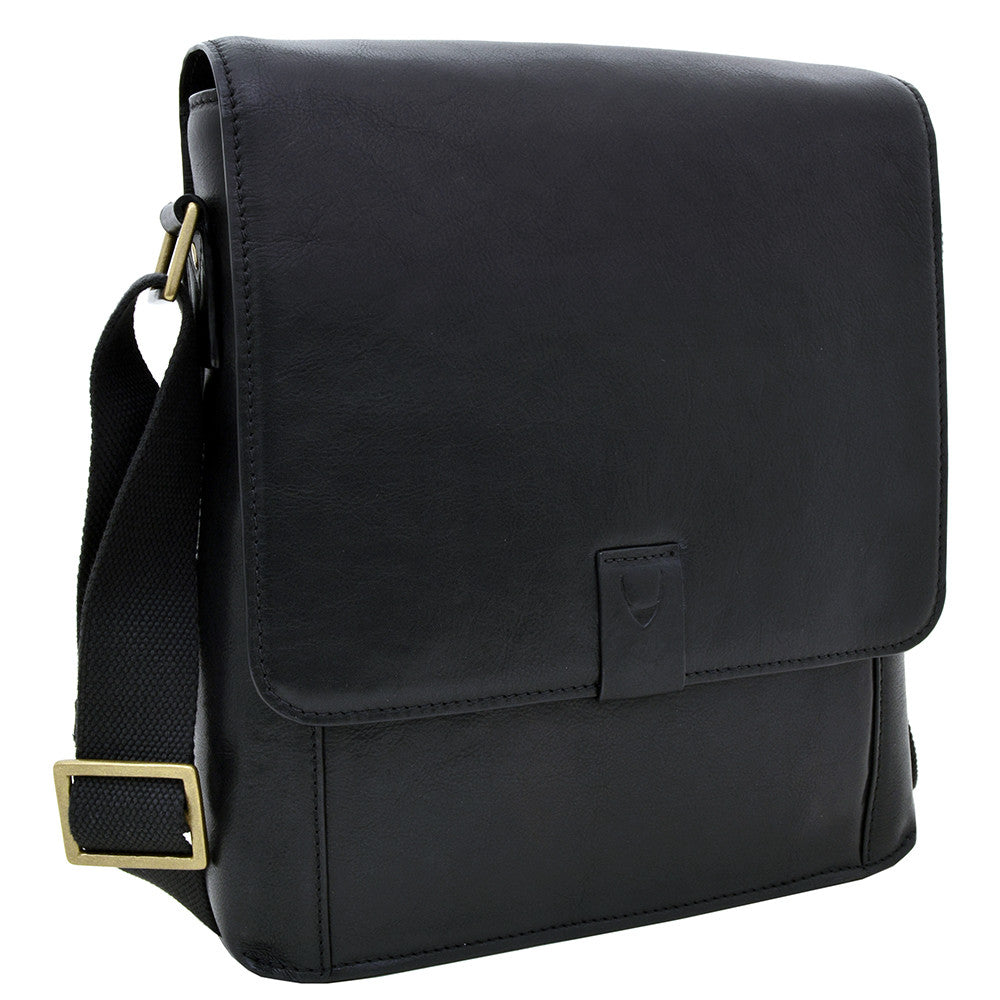 Hidesigns Aiden Genuine Leather Medium Crossbody is a dark brown shoulder bag featuring a wide strap and rectangular brass buckle.