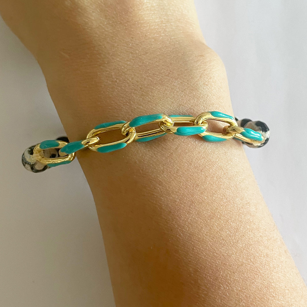 Gena Myints Animal Pattern Agate Turquoise Enamel Link Stretch Bracelet features black and white marbled beads with turquoise chain links accented in gold.