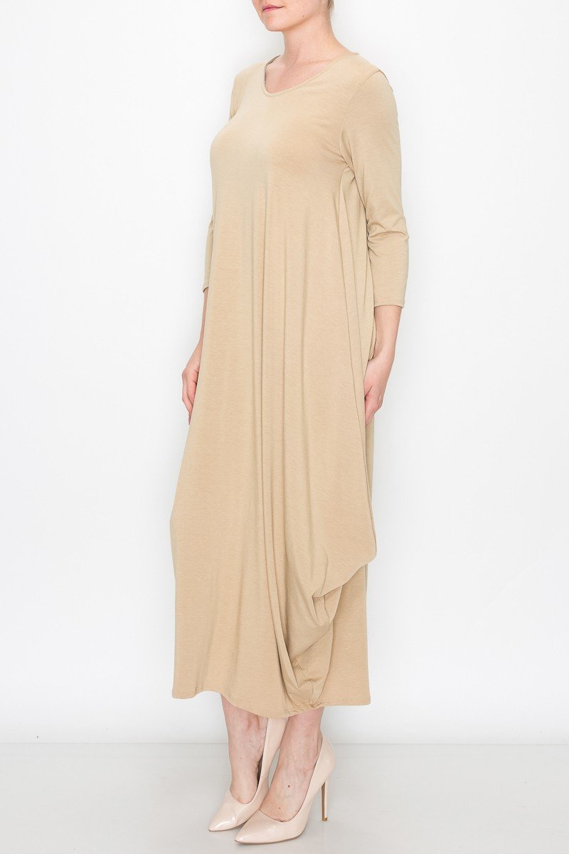 A person poses against a white background wearing the Stylespect Solid Balloon Dress in beige, featuring long sleeves and paired with beige heels, with one hand on their hip.
