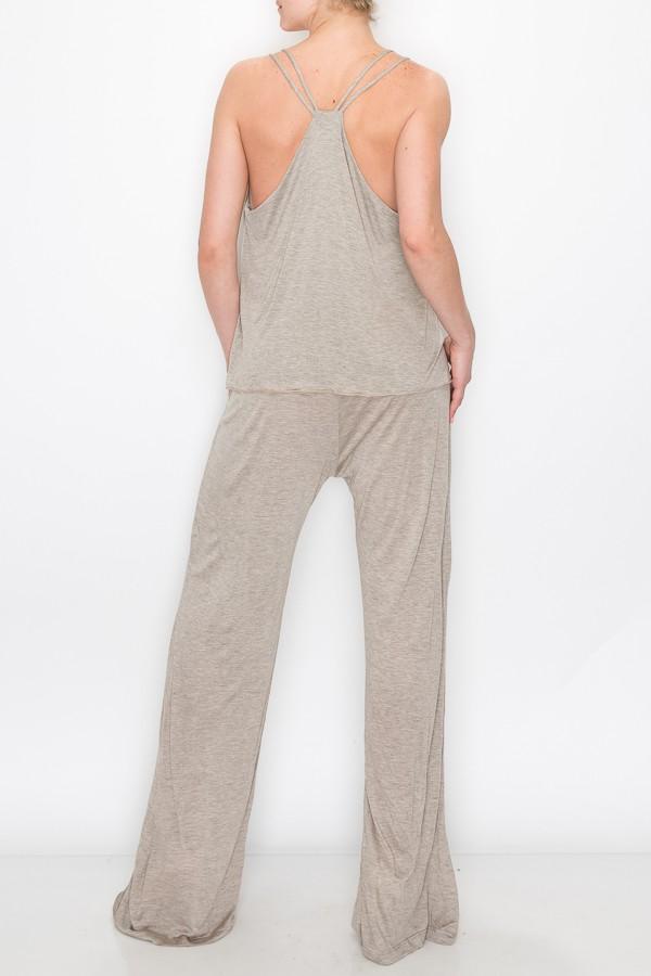 A person models the Stylespect Layered Jumpsuit in khaki, featuring a light gray, sleeveless, loose-fitting design, against a plain white backdrop.