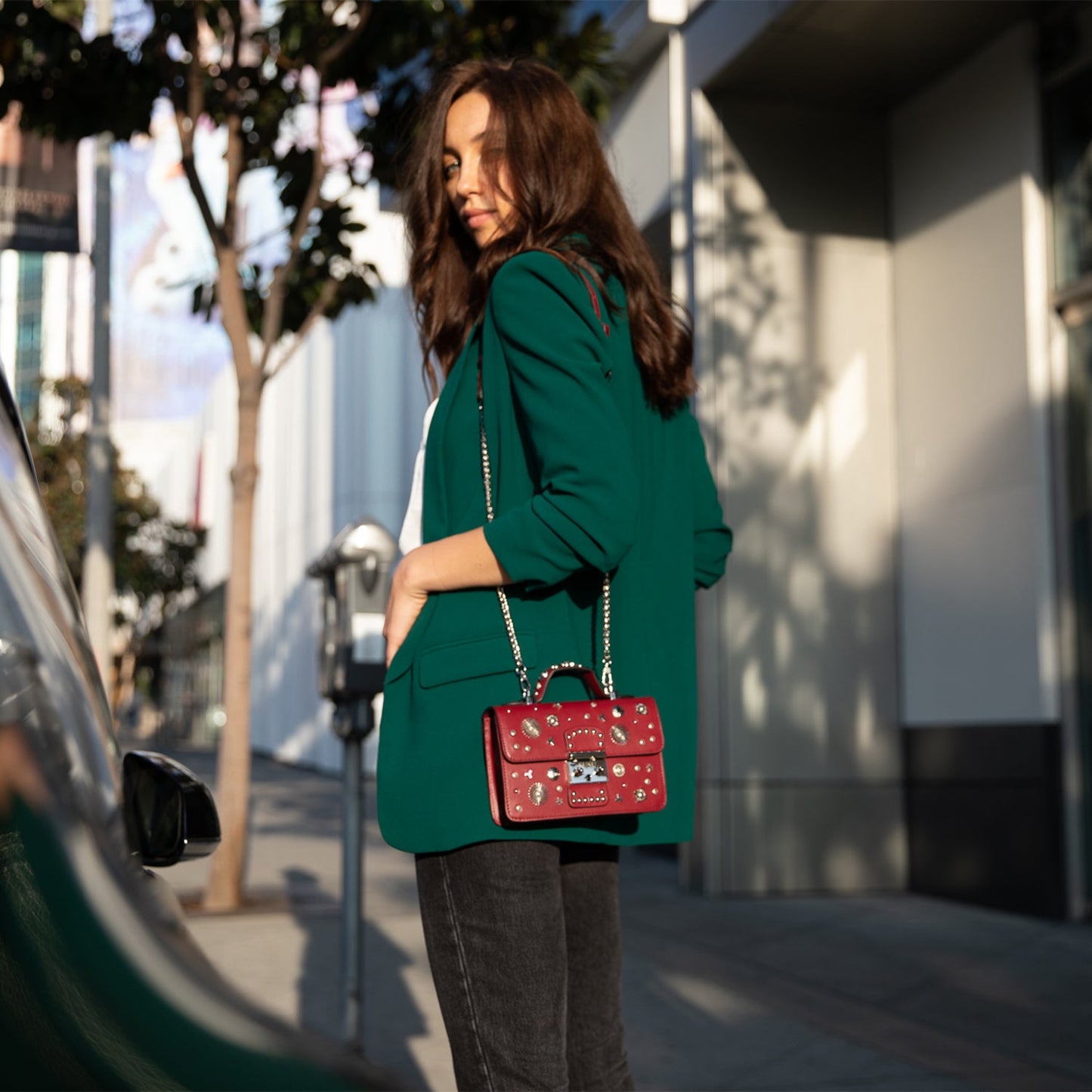 Burgundy leather handbag with silver studs, a short handle, and chain shoulder strap, featuring a SUSU engraved metal clasp.