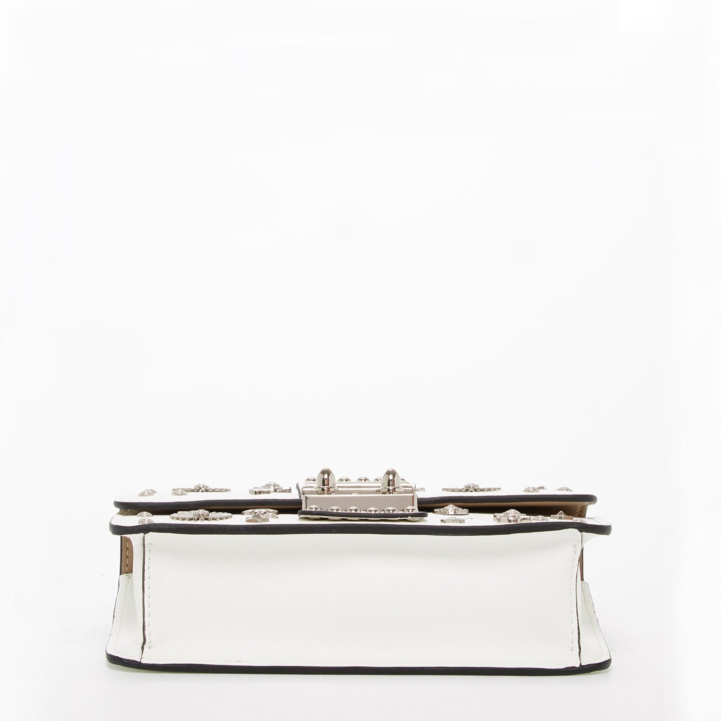 The Hollywood White Leather Crossbody Bag by SUSU features silver stud embellishments, a chain strap, a top handle, and a front clasp with the SUSU brand name.